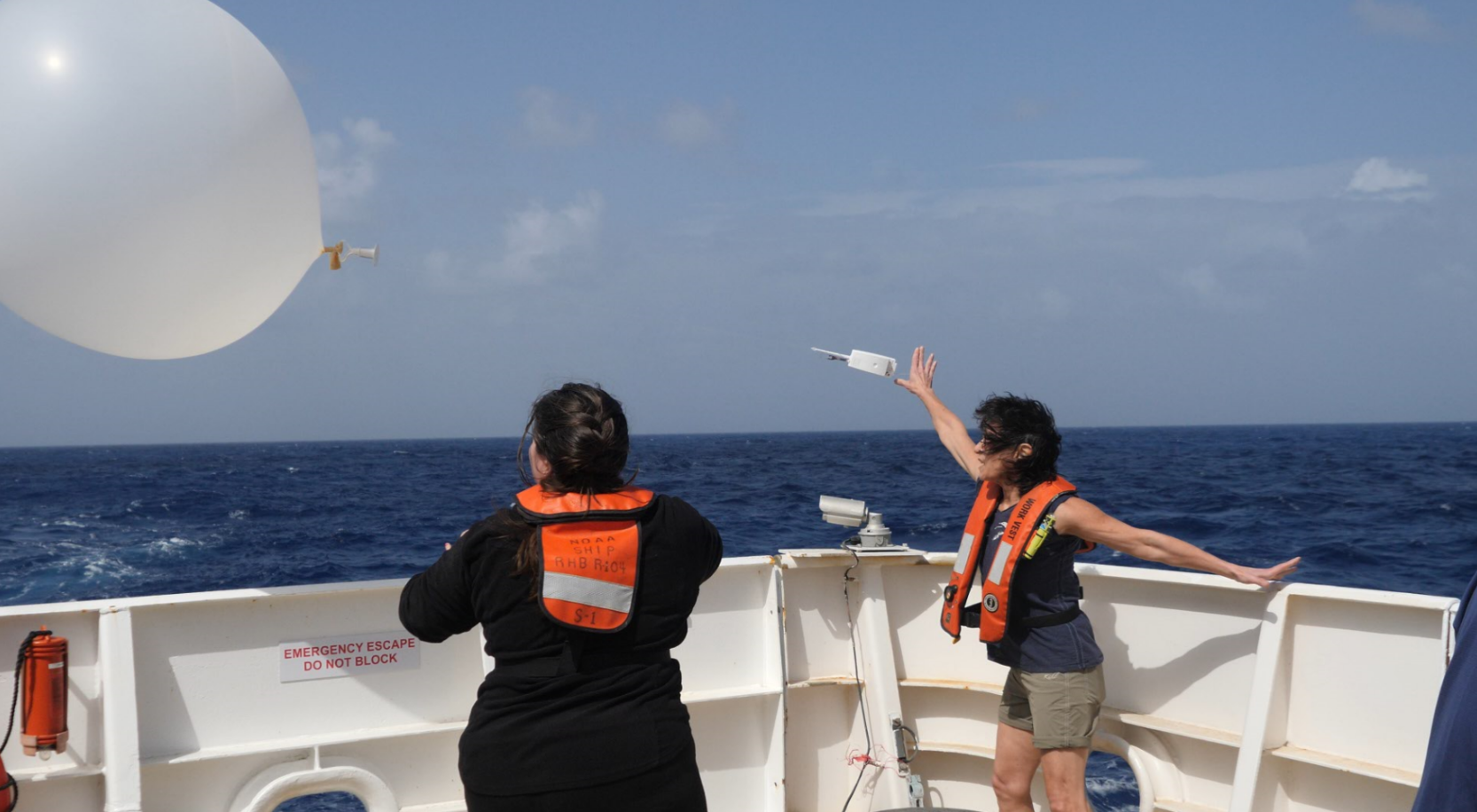 PSD's Janet Intrieri (right) launches a radiosonde from the back of the ship.