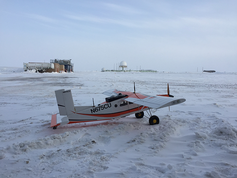 The Pilatus in front of the ARM mobile facility and the U.S. Air Force radar facility at Oliktok Point, during the ERASMUS field campaign in 2016. (Credit: Gijs de Boer, CIRES)