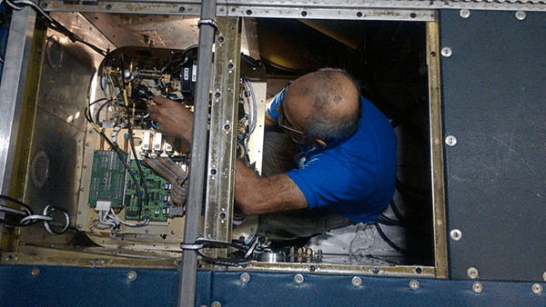 Engineer Sergio Pezoa installing the W-Band radar in the belly of NOAA's P-3 aircraft.