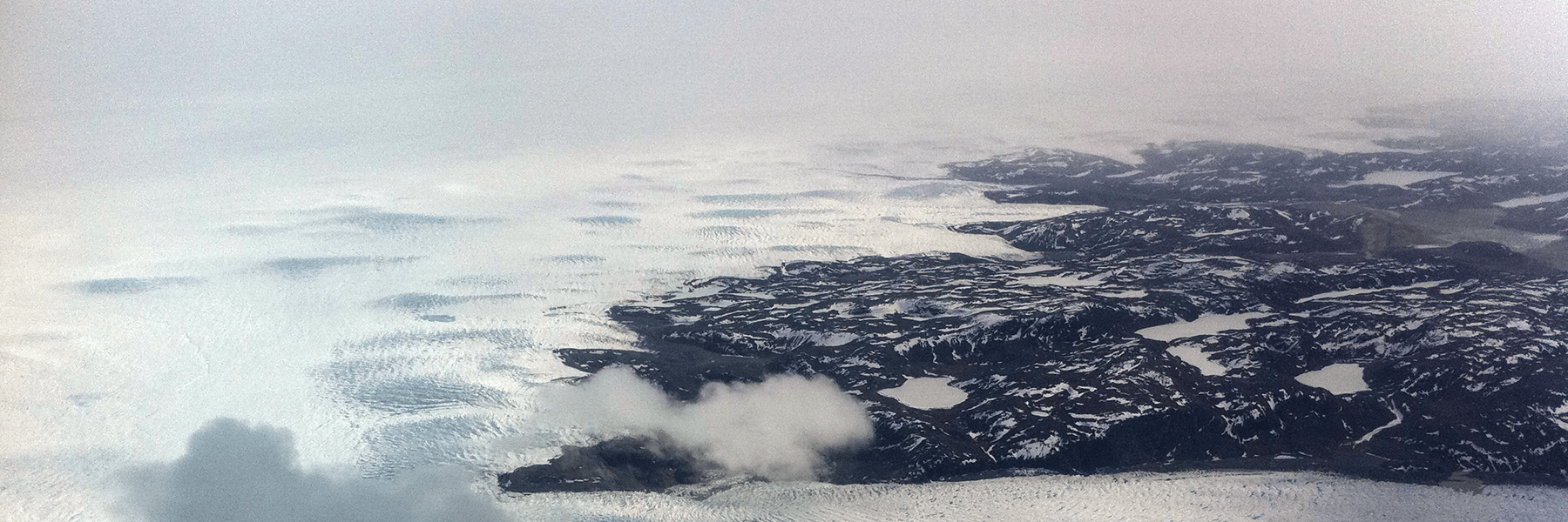 The southwest edge of the Greenland Ice Sheet, partially covered in low-level, opaque clouds. Credit: Matthew Shupe, CIRES