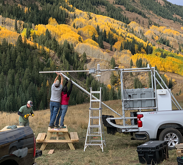 Researchers install the ASFS at the Kettle Ponds field site