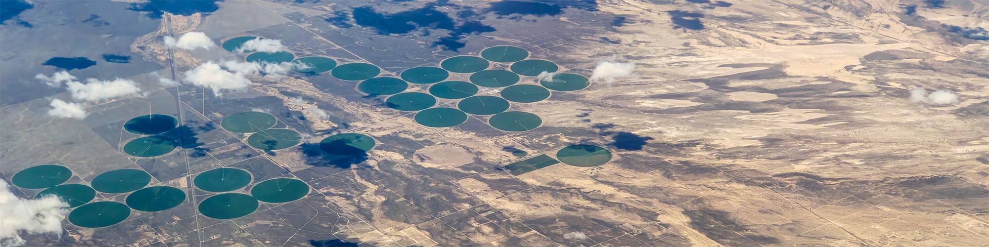 Aerial view of midwest irrigation crop circles surrounded by arid land | Adobe Stock